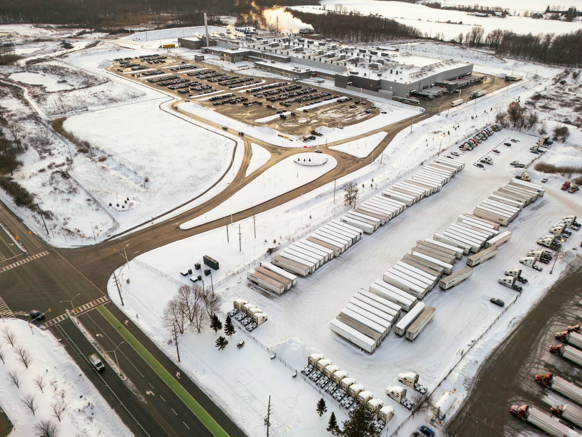 Aerial view of a distribution centre and trucks in snow